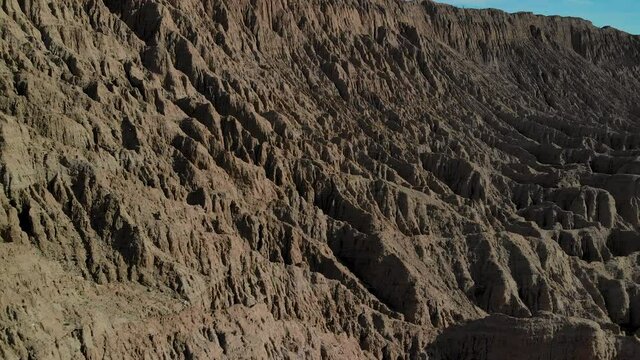 Cinematic aerial flyover of badlands at Font's Point in Anza Borrego Desert State Park in Southern California