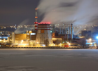 steam from thermal power plant night view ahead of the pond