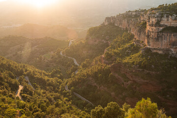 A windy road leads up forest mountainside up the Catalan town of Siurana. This impressive plateau...