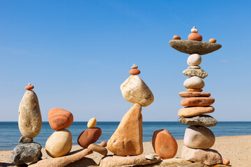 Several Rock zen pyramids of colorful pebbles on a beach on the background of the sea. Concept of...