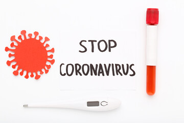Text Stop Coronovirus with thermometer and test tube on white background