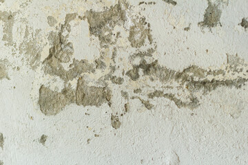 Crumbled paint gives a clear view of the bare concrete. Wear and tear painter renovate renovate own property invest home decay cheap expire abandon investment backlog project handyman craftsman repair