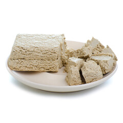 Sunflower halva on plate on white background isolation