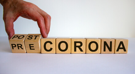 Hand turns cubes and changes the expression 'pre corona' to 'post corona'. Covid-19 pandemic...