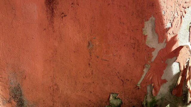 Sunlight & sun ray drop shadow on Red cement or concrete wall with dirty  plaster texture & grange or rusty wallpaper surface of old house building in hot & warm weather, factory or industrial concept