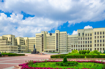 Fototapeta na wymiar The Government House constructivism style building and Vladimir Lenin statue on Independence Square in Minsk city historical centre, blue sky white clouds in sunny summer day, Republic of Belarus