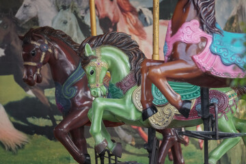 Close up of Carousel that has no customers to play. Colorful three horses in merry-go-round ready...