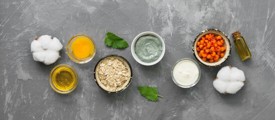 Obraz na płótnie Canvas Natural ingredients for homemade cosmetic masks on a gray concrete background, banner. The concept of beauty and rejuvenation. Top view, flat lay, copy space.