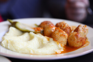 On dinner plate, mitbola mashed potatoes and pickled cucumber. Menu for cafes and restaurants concept