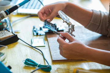 Technician hands examining  circuit board stock photo