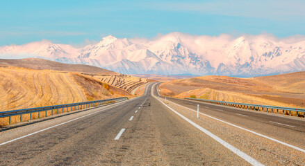 Curve asphalt highway road with cars in the form of mirage against Taurus mountain