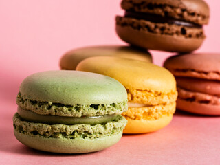 Delicious colorful macarons on pink background