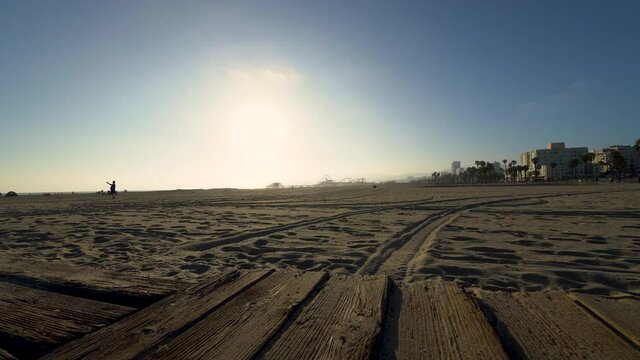 Cinematic tracking shot of boardwalk at Santa Monica Beach in Los Angeles, California