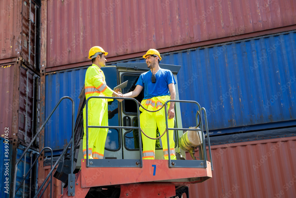 Poster foreman and container worker shaking hands at container cargo,business logistic concept,import and e