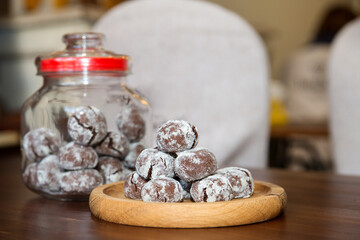 Glass jars with homemade cookies. Shortbread and biscuit cookies on a wooden table. Homemade baking.
