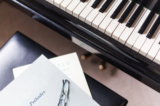 Challenging music books are waiting for you to play piano lessons in front of the piano. Teacher education pianist frederic chopin beethoven romantic music school
