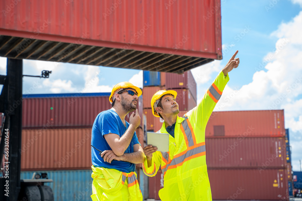Aufkleber engineer and supervisor checking and control loading containers box from cargo at container cargo,bu