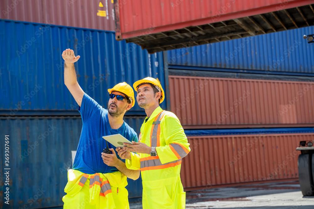 Aufkleber foreman and staff checking at container cargo harbor holding tablet to loading containers for logist