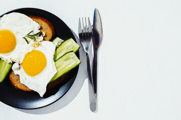 Fried eggs on the plate, healthy breakfast and proper nutrition