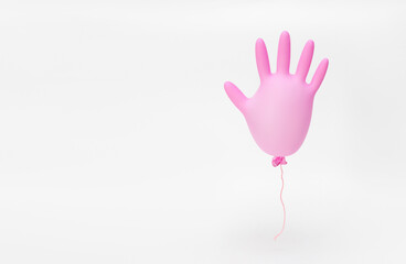 Pink flying inflated surgical glove on a white background. Minimal concept. Protection and prevention against coronavirus.