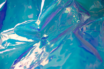Blue soft focus holographic wallpaper. Wrinkled foil texture. Blurred abstract concept.