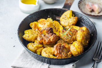 Homemade baked smashed baby potatoes with garlic, salt and herbs