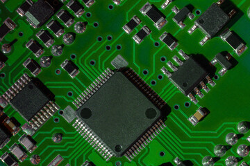 Macro close-up shot of green circuit board, computer motherboard Components: microcircuits,...
