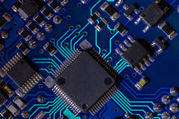 High-tech electronic board (PCB) with processor, microcircuits and luminous digital electronic signals. Close up macro photography
