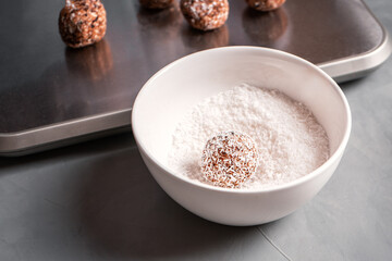 The date candy is in a bowl with coconut shavings