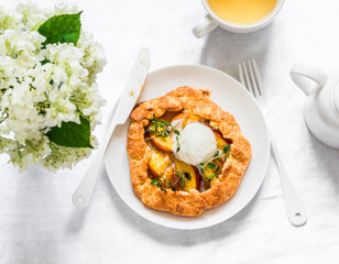 Peaches galeta with ice cream, green tea, flowers on a light background, top view. Flat lay