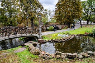 Fototapeta premium The city canal park in Riga, Latvia and bridge with locks
