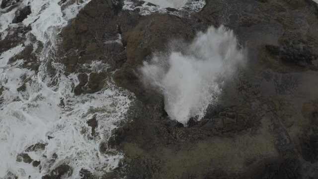 Cinematic aerial shot of Thor's Well sea cave skylight in Oregon Coast