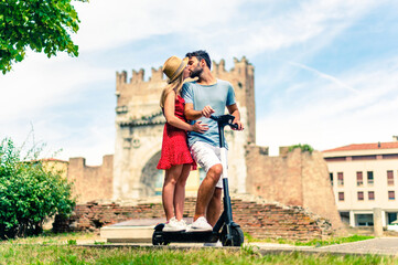 Lovers on the electric scooter kissing each other