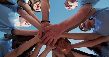 Happy volunteers help to save nature collecting garbage, rubbish, trash. Enthusiastic activists starting work with cheering and stacking hands in the circle. Natural environment, pollution concept. - Powered by Adobe