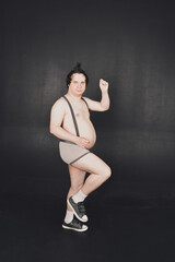 Obraz premium funny fat guy does physical exercises and moves in different poses