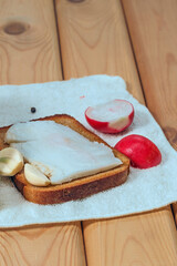 composition with bread, salty bacon , garlic on wooden table