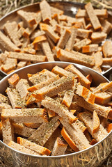 Rusks with oil are cooked on the fire. Many crackers are fried in camping conditions. Texture of dry bread close up..