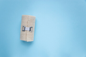 Beige medical bandage roll isolated on white background with copy space. Sterile elastic bandage roll