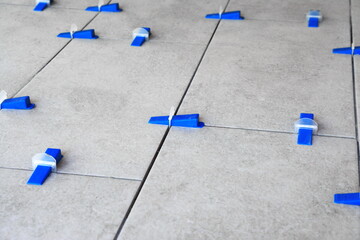 Tile leveling system with plastic clips and wedges, shot while the tile mortar sets