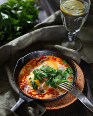 Shakshuka fried eggs in a cast iron pan