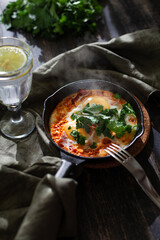 Shakshuka fried eggs in a cast iron pan