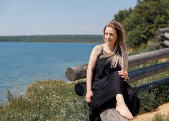 young woman sitting on the shore