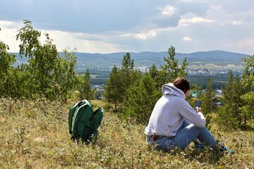 Fototapeta na wymiar Girl admires beautiful panoramic view, Travels in the South Urals