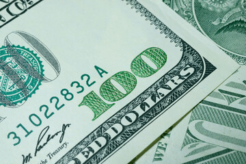 Part of the one hundred USA dollar banknote with number 100 close up, writing Federal Reserve Note