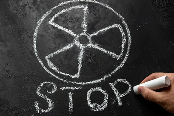 writes stop under the symbol of nuclear weapons and radiation