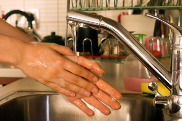 Hand washing in kitchen sink