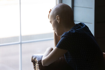 Unhappy ill young Caucasian hairless woman suffer from oncology feel stressed frustrated with life...