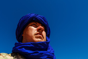 Portrait of a man in a blue turban. Sahara Desert.