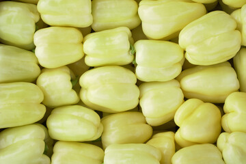 freshly harvested sweet green peppers at a local market, close up