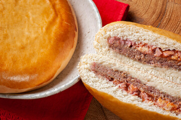 .Brazilian roasted appetizer stuffed with hamburger meat, ham and tomato sauce.